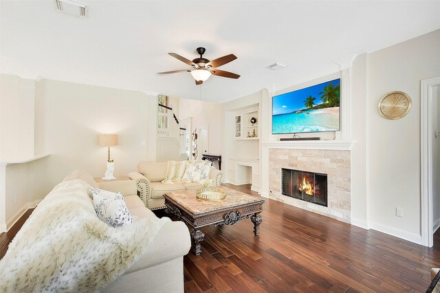 14010 Lakewood Crossing Blvd, Houston, TX 77070 - living room with a glass covered fireplace, ceiling fan, wood finished floors, and built in shelves