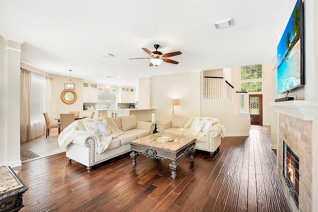 14010 Lakewood Crossing Blvd, Houston, TX 77070 - living area with stairs, dark wood-style flooring, a ceiling fan, and a tile fireplace