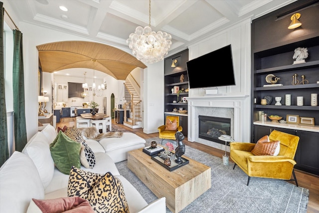 619 W 26th St, Houston, TX 77008 - living room with a chandelier, arched walkways, wood finished floors, a fireplace, and beamed ceiling