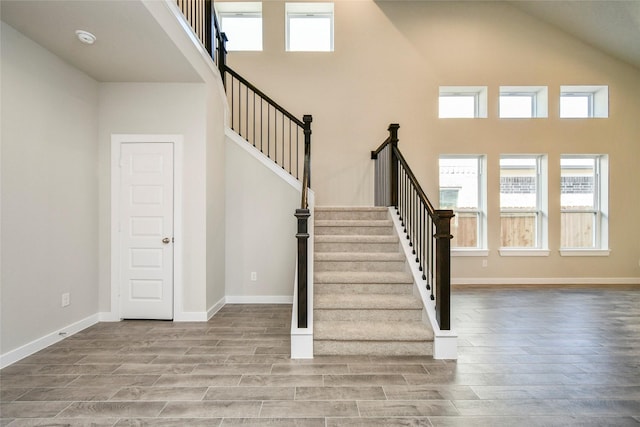 11102 Gardenia Creek Dr, Houston, TX 77044 - stairs featuring a high ceiling, wood finished floors, and plenty of natural light