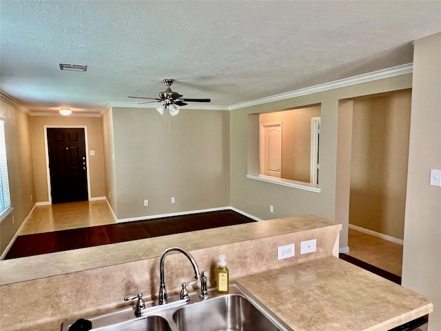 9515 Lower Ridgeway, Houston, TX 77075 - kitchen featuring crown molding, ceiling fan, a textured ceiling, and light countertops