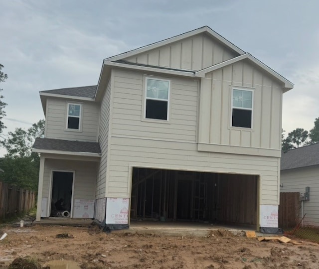 16942 Needlepoint Dr, Conroe, TX 77302 - view of front of home with board and batten siding, a garage, and roof with shingles