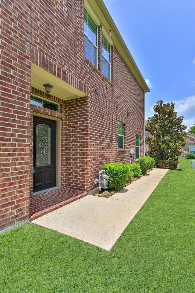 10903 Paterno Dr, Houston, TX 77064 - entrance to property with a yard and brick siding