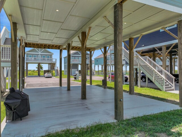 1032 Sunset Cir W, Crystal Beach, TX 77650 - view of patio featuring stairway, a carport, and area for grilling