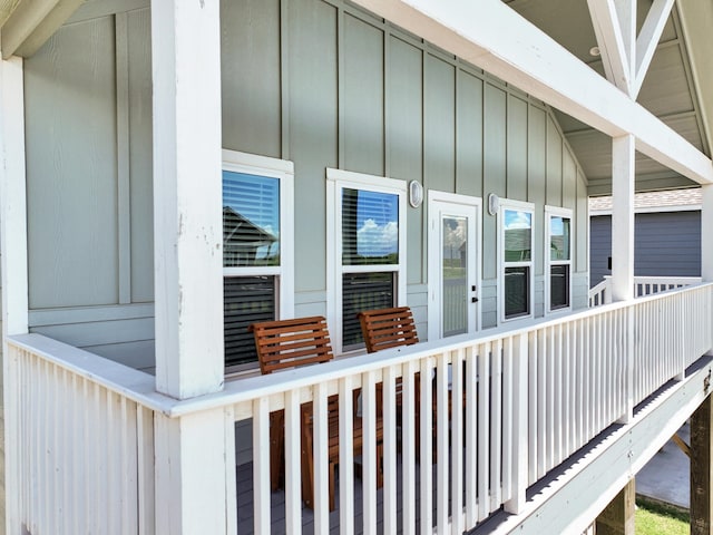 1032 Sunset Cir W, Crystal Beach, TX 77650 - doorway to property with board and batten siding and covered porch