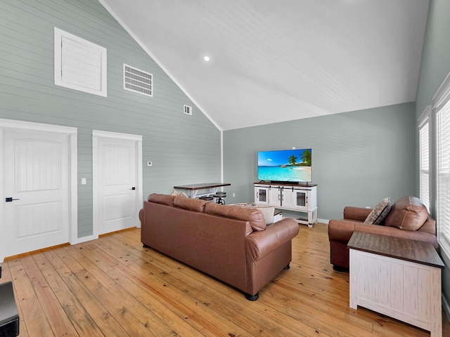 1032 Sunset Cir W, Crystal Beach, TX 77650 - living room with light wood-style floors, high vaulted ceiling, wood walls, and recessed lighting