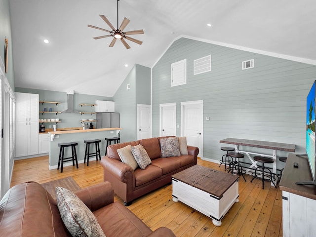 1032 Sunset Cir W, Crystal Beach, TX 77650 - living area with a ceiling fan, light wood-type flooring, high vaulted ceiling, recessed lighting, and wood walls