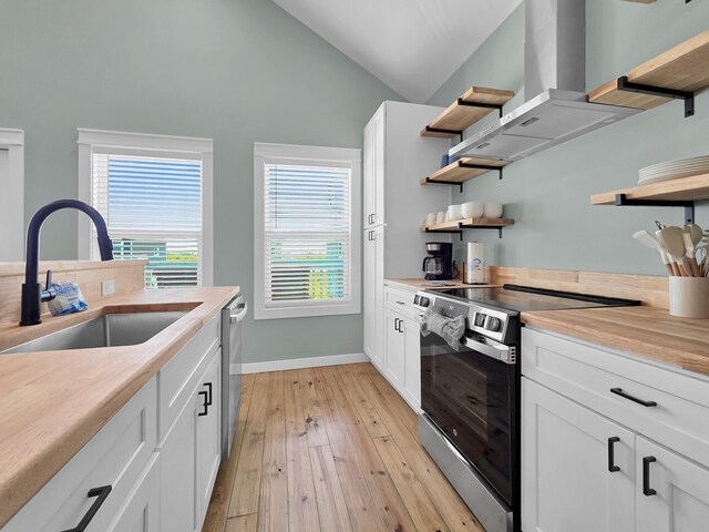 1032 Sunset Cir W, Crystal Beach, TX 77650 - kitchen featuring stainless steel appliances, open shelves, wall chimney range hood, healthy amount of natural light, and high vaulted ceiling