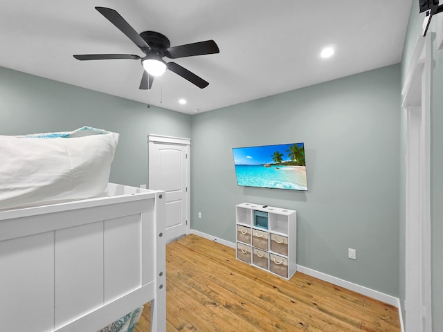 1032 Sunset Cir W, Crystal Beach, TX 77650 - unfurnished bedroom featuring light wood-type flooring, recessed lighting, and a ceiling fan