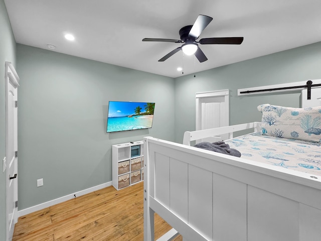 1032 Sunset Cir W, Crystal Beach, TX 77650 - bedroom featuring light wood-style flooring, a ceiling fan, and recessed lighting