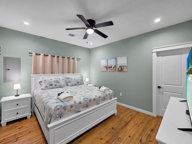 1032 Sunset Cir W, Crystal Beach, TX 77650 - bedroom featuring light wood-style flooring, electric panel, recessed lighting, and ceiling fan