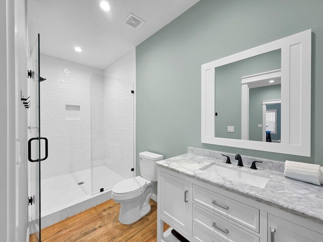 1032 Sunset Cir W, Crystal Beach, TX 77650 - full bath with wood finished floors, vanity, a shower stall, and recessed lighting