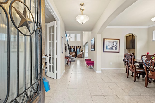 1115 Tydeman Ct, Katy, TX 77494 - entryway with arched walkways, light tile patterned flooring, and ornamental molding