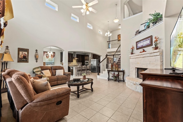 1115 Tydeman Ct, Katy, TX 77494 - living room with a chandelier, arched walkways, ceiling fan, stairway, and a high ceiling