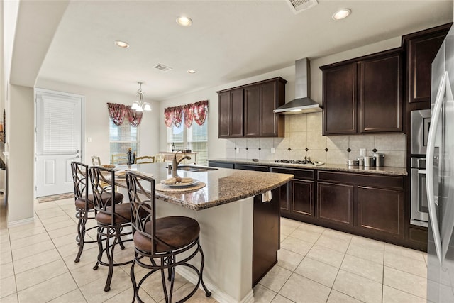 1115 Tydeman Ct, Katy, TX 77494 - kitchen featuring wall chimney range hood, light tile patterned floors, stone counters, decorative backsplash, and recessed lighting
