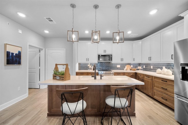 6804 Westview Dr Unit 3104, Houston, TX 77055 - kitchen featuring appliances with stainless steel finishes, light wood-style floors, decorative backsplash, light countertops, and recessed lighting