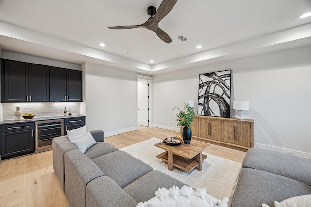 608 E 25th St, Houston, TX 77008 - living room featuring wet bar, wine cooler, light wood-style flooring, recessed lighting, and a ceiling fan