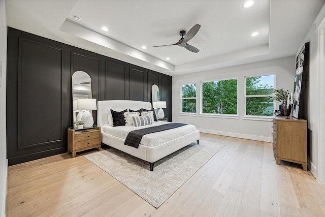 608 E 25th St, Houston, TX 77008 - bedroom featuring a tray ceiling, light wood-type flooring, recessed lighting, and ceiling fan