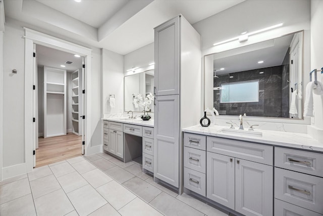 608 E 25th St, Houston, TX 77008 - bathroom featuring vanity, tiled shower, a spacious closet, tile patterned floors, and recessed lighting