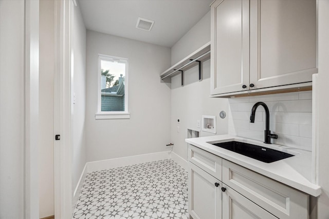 608 E 25th St, Houston, TX 77008 - laundry room with hookup for an electric dryer, cabinet space, hookup for a washing machine, and tile patterned floors