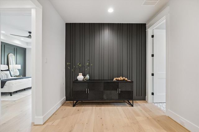 608 E 25th St, Houston, TX 77008 - hallway featuring an accent wall, wood finished floors, and recessed lighting