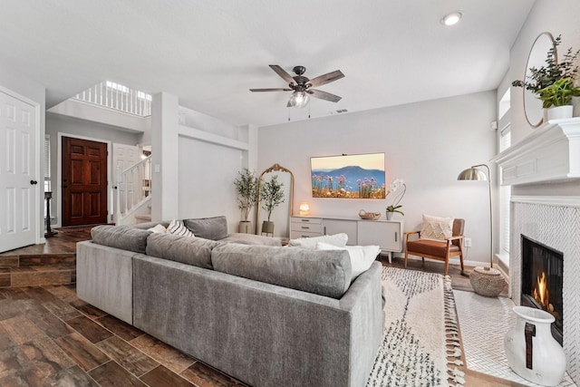 87 E Greenhill Terrace Pl, The Woodlands, TX 77382 - living room with ceiling fan, a lit fireplace, stairway, dark wood finished floors, and recessed lighting