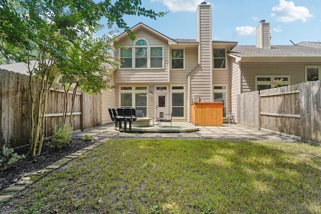 87 E Greenhill Terrace Pl, The Woodlands, TX 77382 - rear view of property featuring a patio area, a chimney, and a fenced backyard