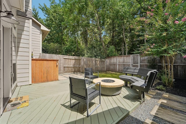87 E Greenhill Terrace Pl, The Woodlands, TX 77382 - wooden terrace with a fire pit and a fenced backyard