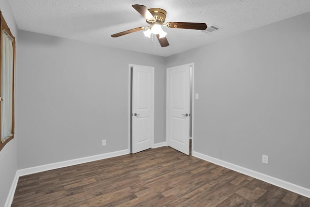 9611 Huntington Hill Dr, Houston, TX 77099 - unfurnished bedroom featuring dark wood-style floors, a textured ceiling, and a ceiling fan