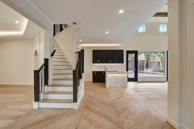 4316 Dickson St, Houston, TX 77007 - stairway featuring recessed lighting, a towering ceiling, and bar area