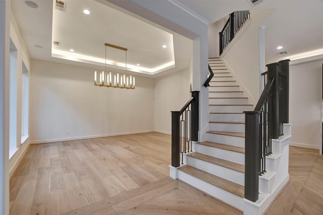4316 Dickson St, Houston, TX 77007 - stairs featuring a raised ceiling, a chandelier, wood finished floors, and recessed lighting