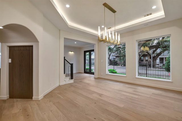 4316 Dickson St, Houston, TX 77007 - unfurnished dining area featuring a tray ceiling, light wood-type flooring, stairway, a chandelier, and recessed lighting