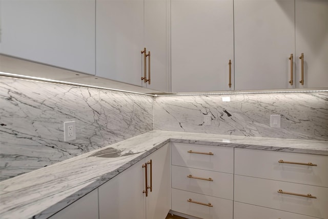 4316 Dickson St, Houston, TX 77007 - kitchen with decorative backsplash, white cabinets, and light stone countertops