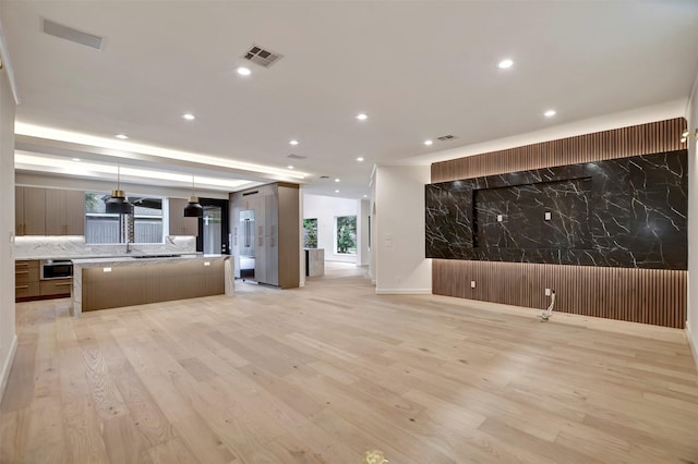 4316 Dickson St, Houston, TX 77007 - unfurnished living room featuring light wood-type flooring and recessed lighting