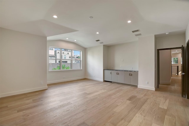 4316 Dickson St, Houston, TX 77007 - spare room featuring vaulted ceiling, light wood-style flooring, and recessed lighting