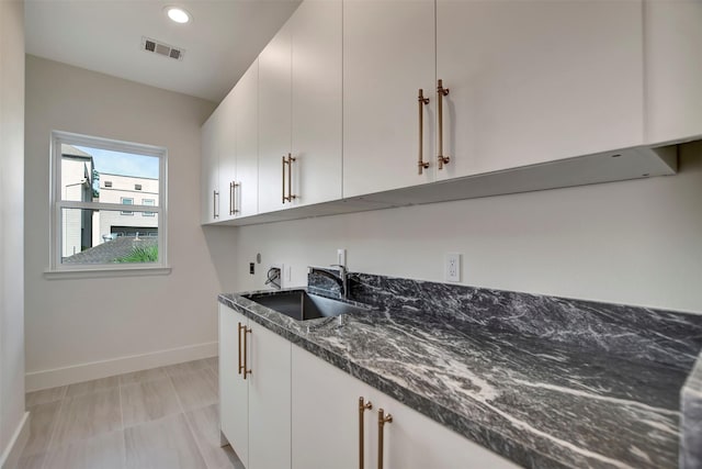 4316 Dickson St, Houston, TX 77007 - kitchen featuring dark stone counters, white cabinets, and recessed lighting