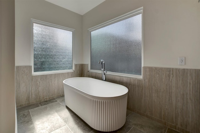 4316 Dickson St, Houston, TX 77007 - full bath with wainscoting, a soaking tub, plenty of natural light, and tile walls