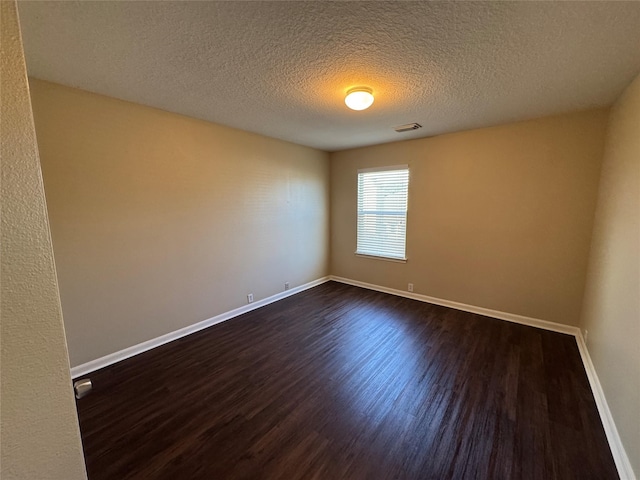 18322 Valiant Brook Ct, Humble, TX 77346 - spare room with dark wood-type flooring and a textured ceiling