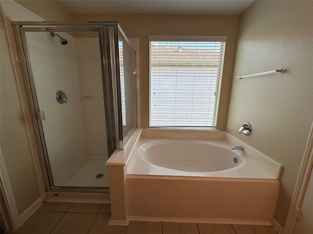 18322 Valiant Brook Ct, Humble, TX 77346 - bathroom featuring tile patterned floors, a bath, and a shower stall