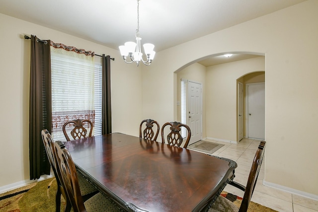 4134 Loft Square Pl, Humble, TX 77346 - dining room with arched walkways, a chandelier, and light tile patterned flooring