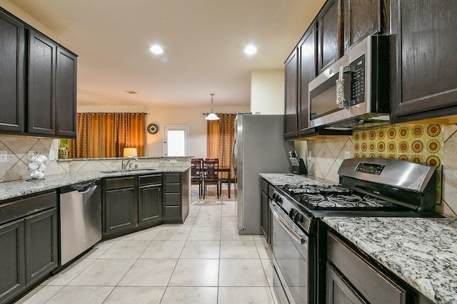 4134 Loft Square Pl, Humble, TX 77346 - kitchen featuring stainless steel appliances, backsplash, light stone counters, and recessed lighting