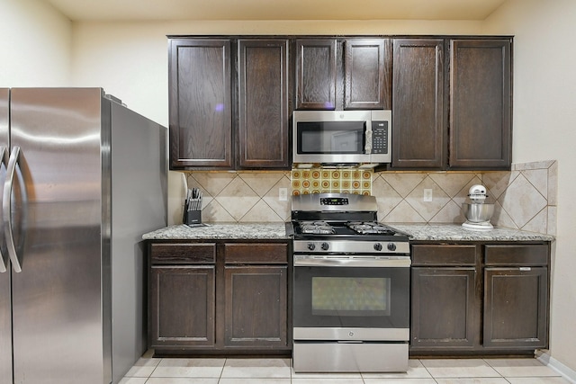 4134 Loft Square Pl, Humble, TX 77346 - kitchen featuring appliances with stainless steel finishes, dark brown cabinetry, tasteful backsplash, and light tile patterned floors