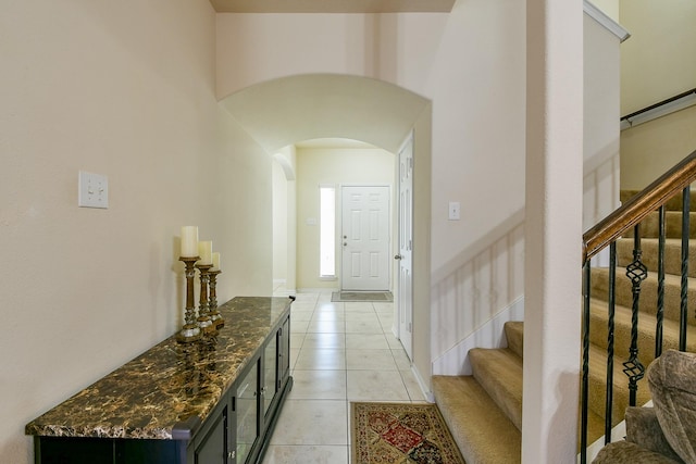4134 Loft Square Pl, Humble, TX 77346 - entryway featuring arched walkways, light tile patterned floors, and stairway