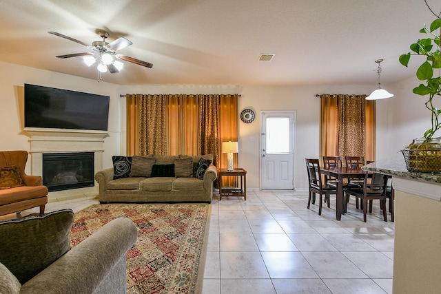 4134 Loft Square Pl, Humble, TX 77346 - living area with ceiling fan, light tile patterned floors, and a glass covered fireplace