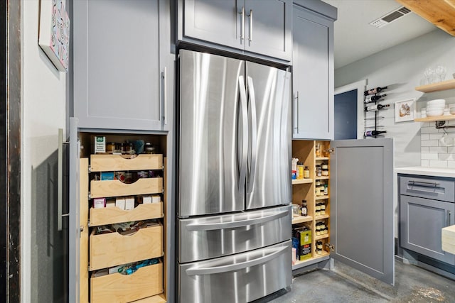 402 E 25th St, Houston, TX 77008 - kitchen featuring freestanding refrigerator, concrete floors, open shelves, gray cabinets, and light countertops