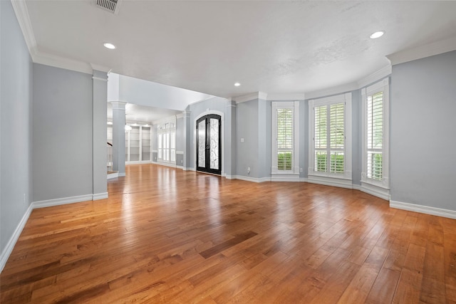 12814 Josey Creek Ct, Cypress, TX 77433 - unfurnished living room with ornate columns, ornamental molding, light wood finished floors, and recessed lighting