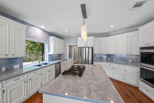 12814 Josey Creek Ct, Cypress, TX 77433 - kitchen with appliances with stainless steel finishes, a center island, white cabinetry, and recessed lighting