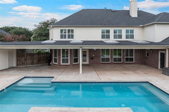 12814 Josey Creek Ct, Cypress, TX 77433 - back of house with a chimney, a patio area, an outdoor pool, and brick siding