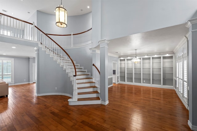 12814 Josey Creek Ct, Cypress, TX 77433 - staircase featuring wood-type flooring, a chandelier, a towering ceiling, decorative columns, and recessed lighting