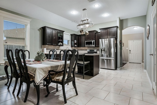 18819 Deer Trace Dr, Crosby, TX 77532 - dining area featuring arched walkways, recessed lighting, and light tile patterned floors